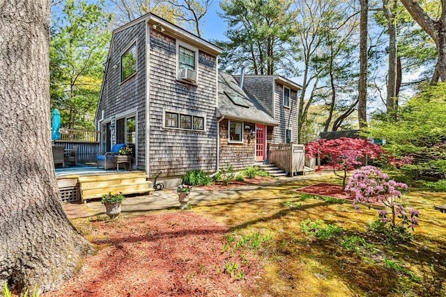 exterior space featuring cooling unit and a wooden deck