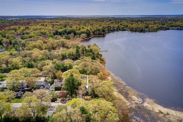 drone / aerial view featuring a water view and a wooded view
