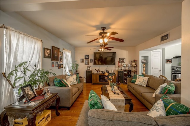 living area featuring ceiling fan, visible vents, and light wood-style floors
