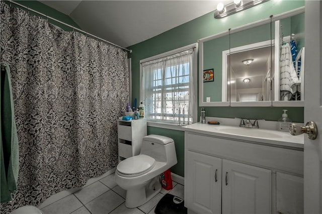 bathroom with vanity, lofted ceiling, tile patterned floors, and toilet