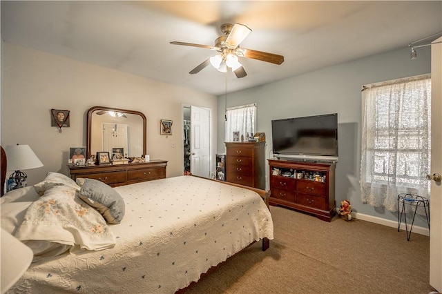bedroom with baseboards, ceiling fan, and carpet flooring