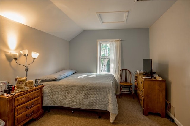 carpeted bedroom featuring attic access and vaulted ceiling