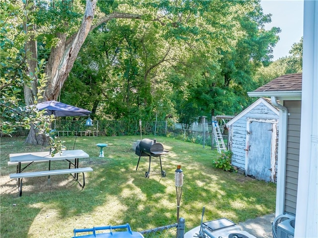 view of yard with a storage unit, a fenced backyard, and an outdoor structure