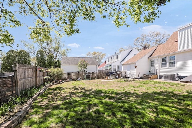 view of yard with entry steps, cooling unit, and a fenced backyard