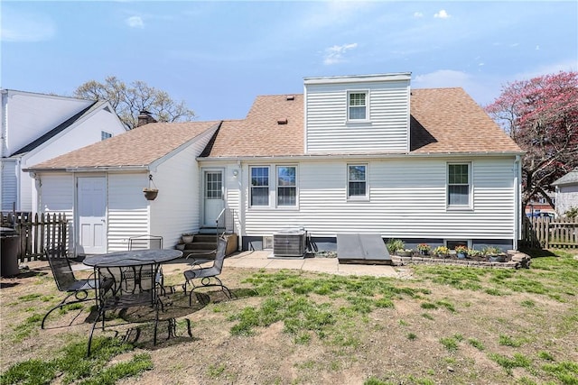 rear view of property with a patio, a shingled roof, fence, and entry steps