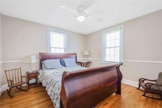 bedroom with baseboards, a ceiling fan, and light wood finished floors