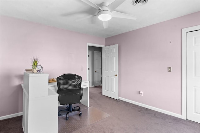 carpeted office space with ceiling fan, visible vents, and baseboards