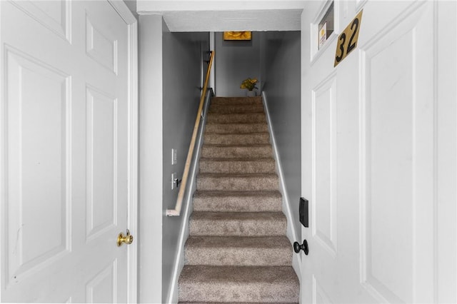 staircase featuring baseboards