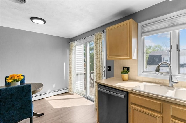 kitchen featuring baseboard heating, light countertops, a sink, dishwashing machine, and light wood-style flooring