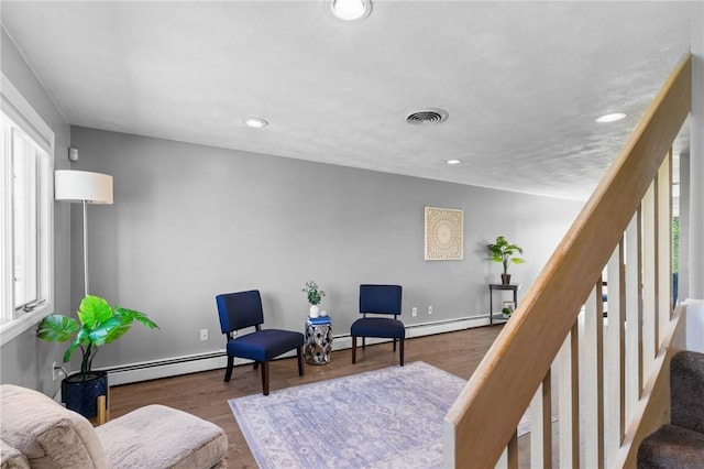 sitting room with plenty of natural light, visible vents, wood finished floors, stairway, and recessed lighting