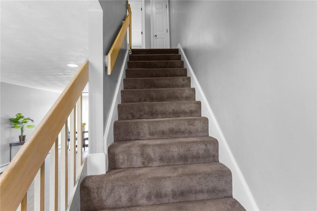 stairs featuring baseboards