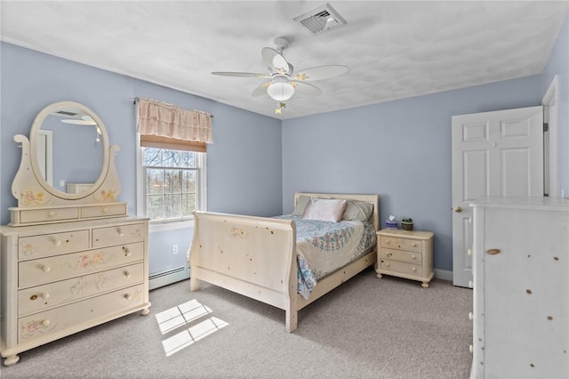 bedroom featuring visible vents, carpet floors, a ceiling fan, baseboards, and a baseboard heating unit