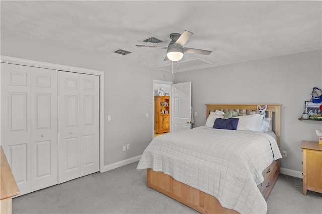 bedroom with baseboards, visible vents, and light carpet