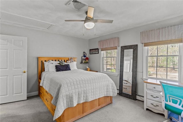 bedroom featuring ceiling fan, light colored carpet, attic access, a baseboard radiator, and visible vents