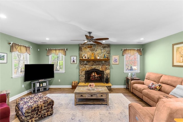 living area with recessed lighting, a ceiling fan, and wood finished floors