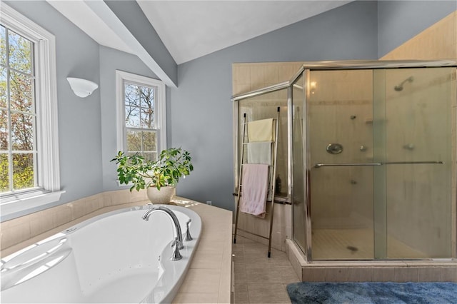 bathroom featuring vaulted ceiling, plenty of natural light, a shower stall, and a bath