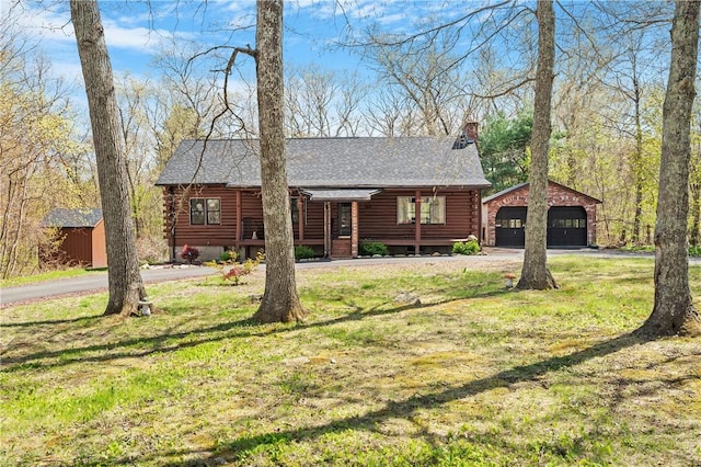 log home with a detached garage, an outdoor structure, log exterior, and a chimney
