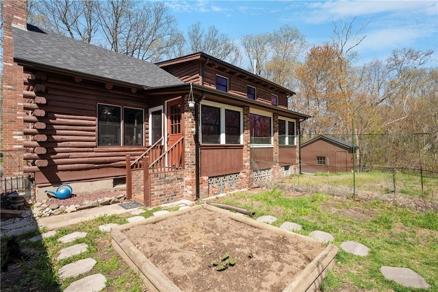 exterior space with log exterior, a shingled roof, and a chimney