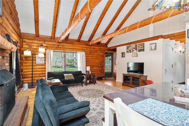living area featuring wood-type flooring, beamed ceiling, log walls, and a wood stove