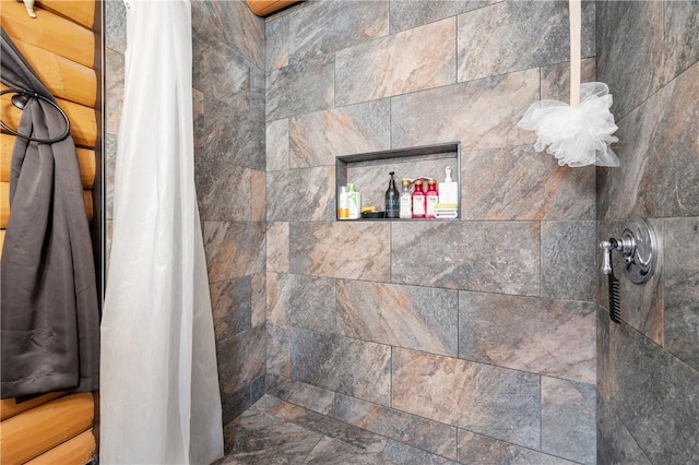bathroom with tiled shower