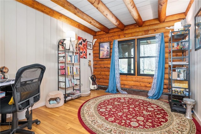 office with wood-type flooring, beamed ceiling, and log walls