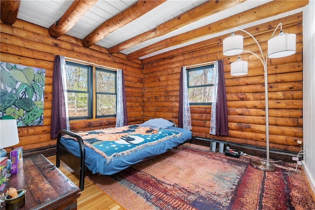 bedroom with log walls, wood ceiling, hardwood / wood-style flooring, and beam ceiling