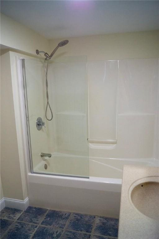 full bathroom featuring baseboards and shower / washtub combination