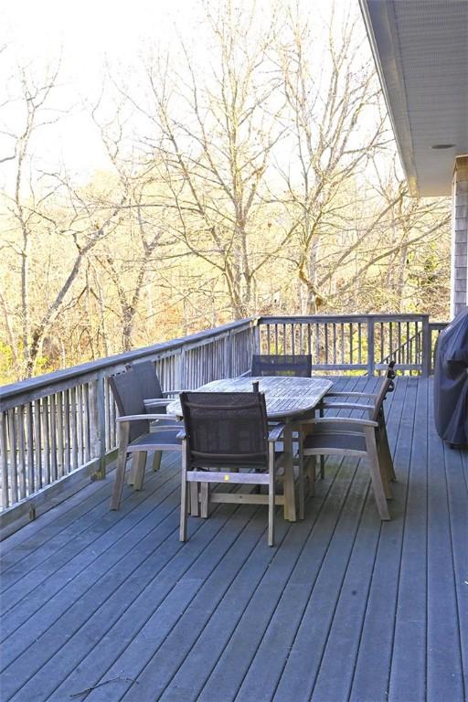 wooden terrace featuring outdoor dining space