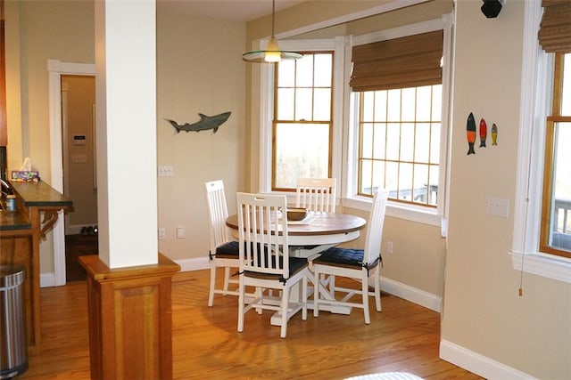 dining room featuring baseboards and light wood-type flooring