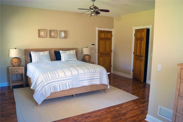 bedroom with visible vents, a ceiling fan, baseboards, and wood finished floors