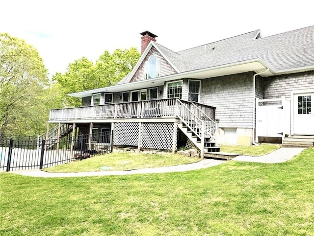 56 Ocean Ridge Dr, Charlestown, RI 02813 - back of property with stairs, a wooden deck, a chimney, and roof with shingles