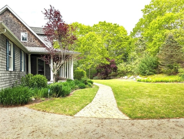 56 Ocean Ridge Dr, Charlestown, RI 02813 - view of grassy yard with a porch