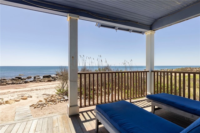 deck featuring a beach view and a water view