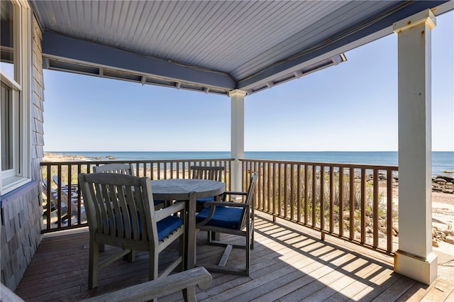 wooden deck featuring a water view and outdoor dining area