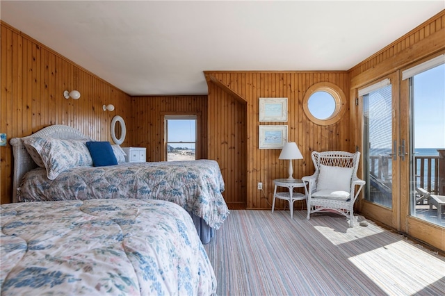 carpeted bedroom with wood walls