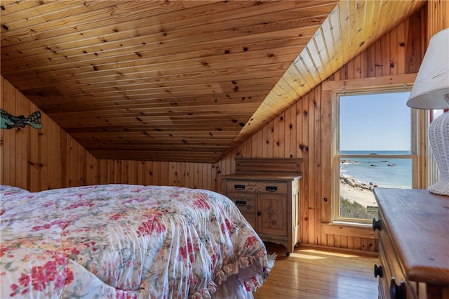 bedroom featuring wood walls, vaulted ceiling, and wooden ceiling