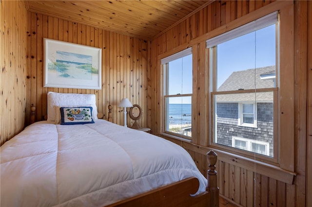 bedroom with wood ceiling and wood walls