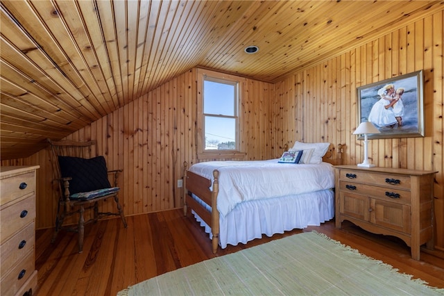 bedroom featuring wood finished floors, wood walls, lofted ceiling, and wooden ceiling