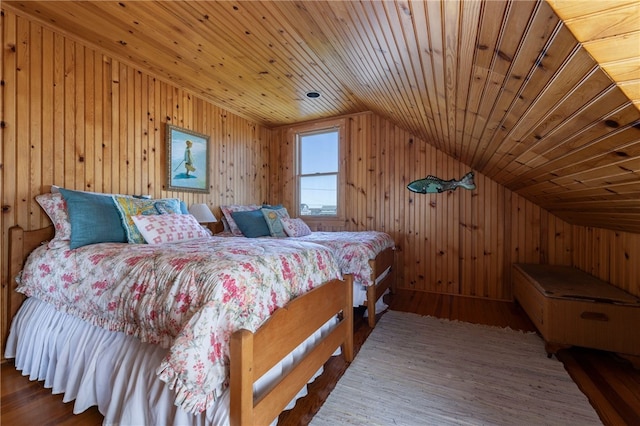 bedroom featuring wooden walls, wood ceiling, vaulted ceiling, and wood finished floors