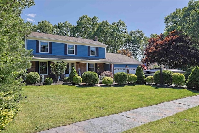 view of front of home featuring a front lawn and a garage