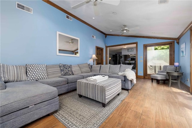 living area featuring crown molding, ceiling fan, light wood-type flooring, and visible vents
