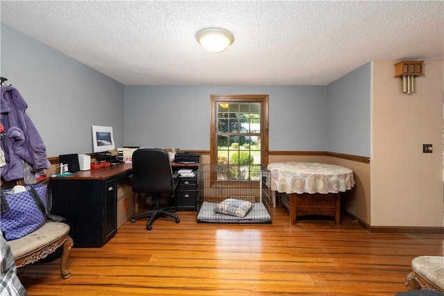 office featuring a textured ceiling and light wood-style floors