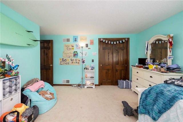 carpeted bedroom with a closet and visible vents