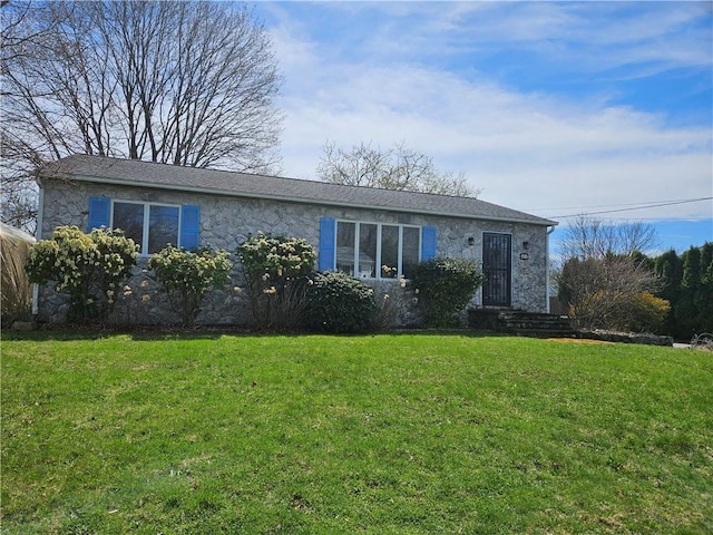 single story home featuring a front lawn and stone siding