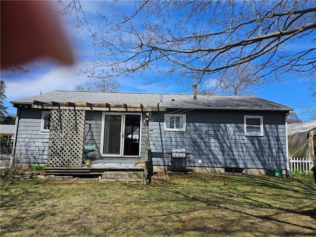 rear view of house with a yard