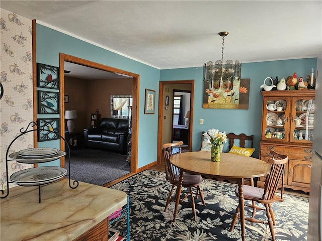 dining space featuring a notable chandelier and ornamental molding