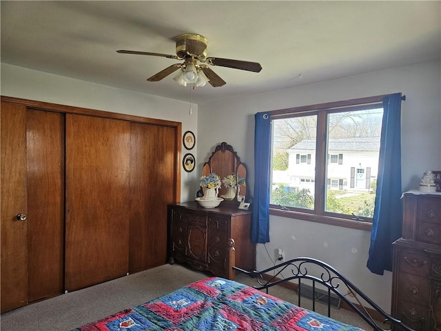 bedroom featuring a closet, ceiling fan, and carpet flooring