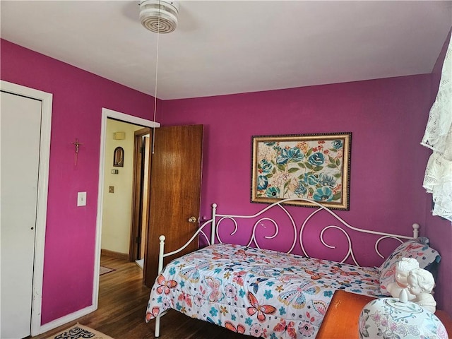 bedroom featuring baseboards and wood finished floors