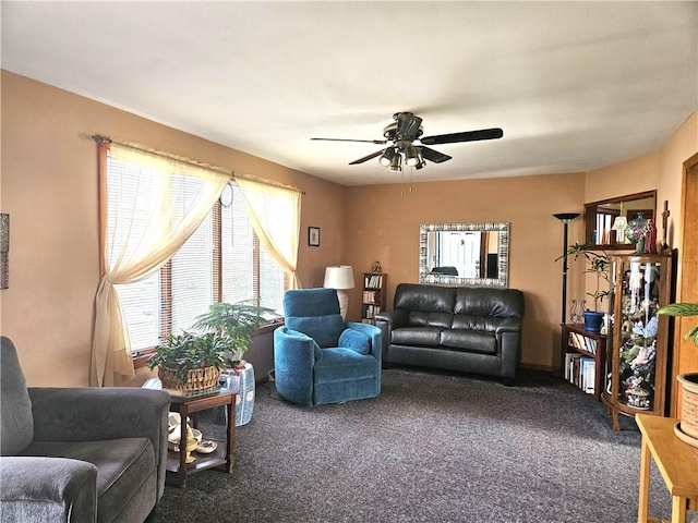 living area featuring carpet floors and a ceiling fan