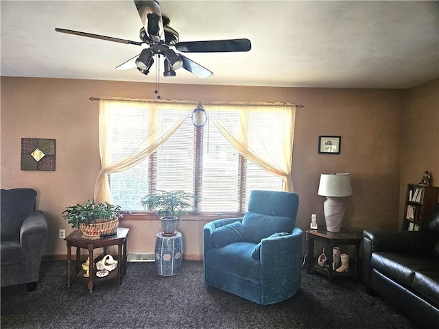 sitting room with carpet floors, ceiling fan, visible vents, and baseboards
